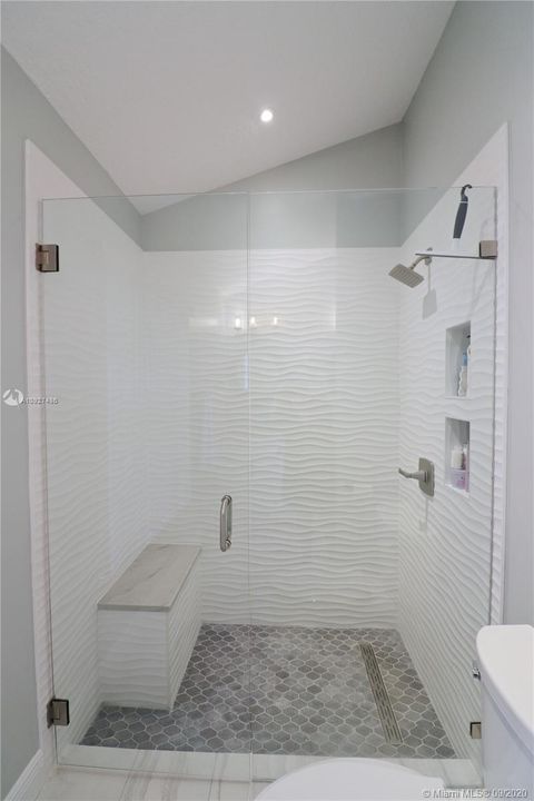 Oversized walk in shower with bench & niches