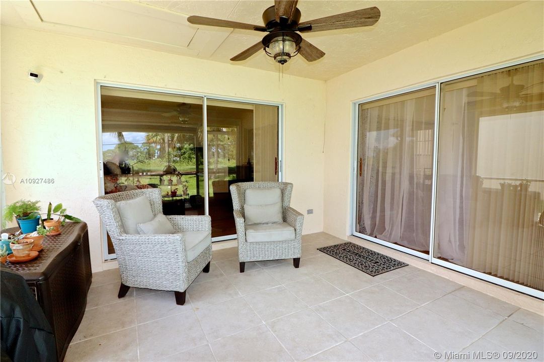 Screened in patio with spectcular views of lush landscaping & nature.
