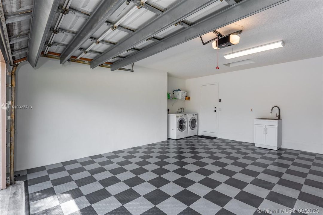 Spotless 2-car garage with Race Deck flooring, ultra quiet, wi-fi, belt driven garage opener, washer and dryer and new sink.