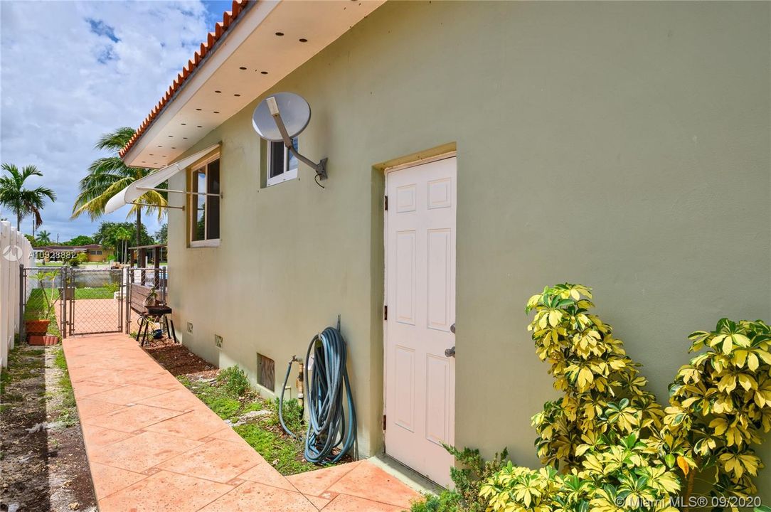 Side yard with door from the garage