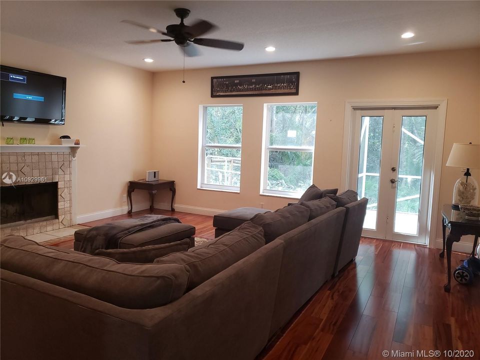 Large den with hardwood flooring and beautiful parklike views. Impact French doors open to private screened patio.