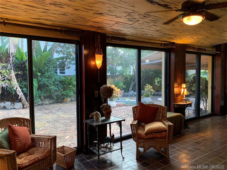 Entry Room with Pecky Cypress Ceiling and View of Private Courtyard.