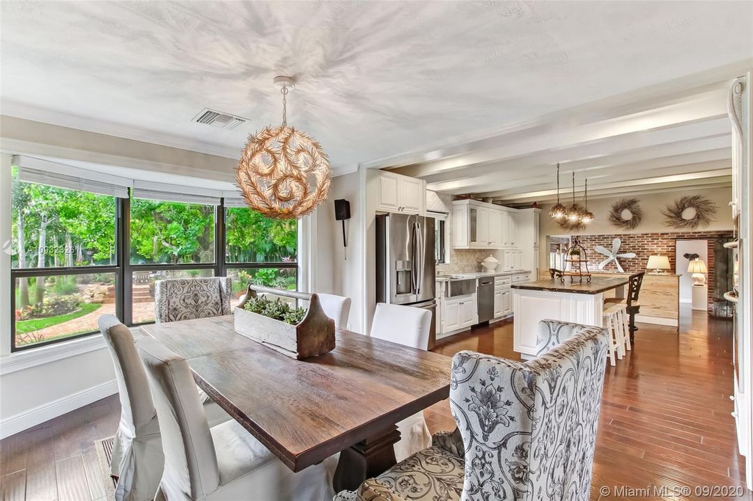 Formal dining room with calming views of beautifully landscaped backyard.