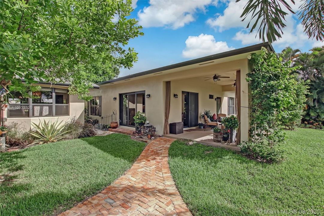 Brick pavers lead to guest house patio.