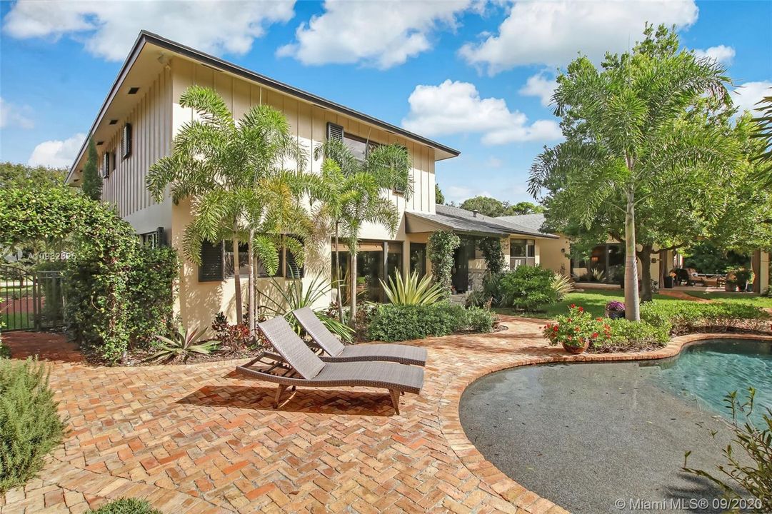 90 sq. ft. brick pavered sun deck surrounding pool with meticulously maintained landscaping upgrades.