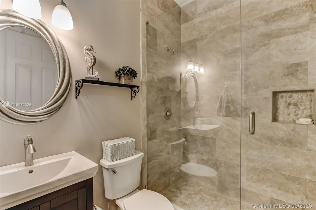 Bath entry from hall or second bedroom providing second en-suite.  Frameless glass shower enclosure.  Beautiful finishes and large linen closet.