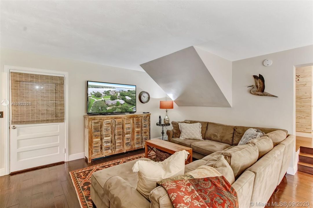 Family room with entrance to two car garage boasting impact double garage doors installed in 2020 with WiFi enabled garage door openers.