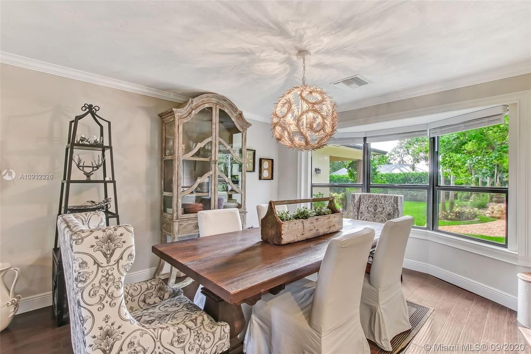 Formal dining room with crown molding, 5 3/4" baseboards and beautiful views.