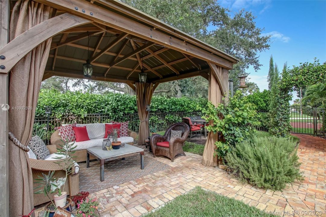 Cypress wood lighted pavilion with Chicago Brick flooring overlooking pool.  BBQ station is adjacent to the pavilion.