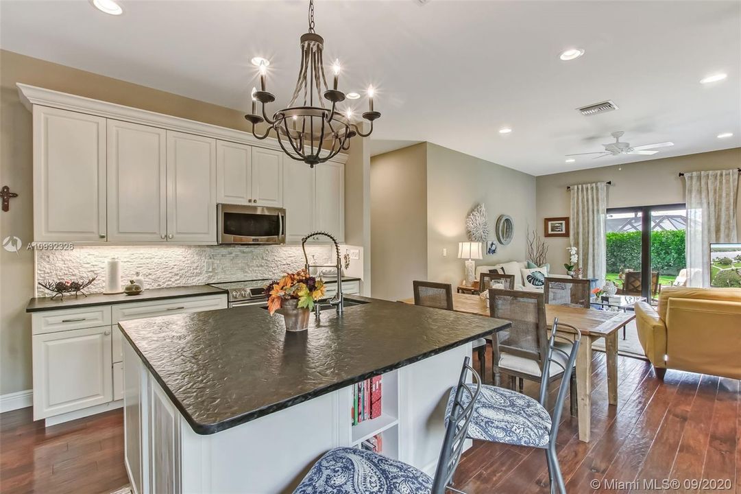 Guest house custom kitchen with 5 foot island with leathered granite countertop.