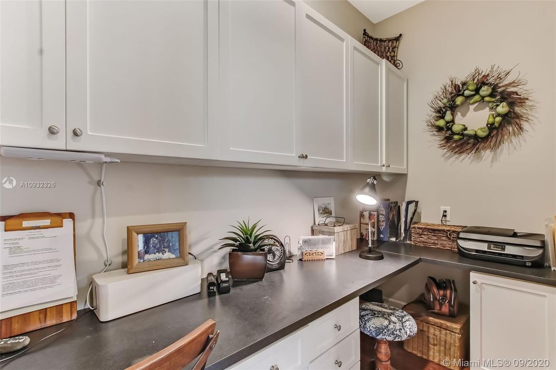 Guest house office with built-in cabinets and desk.