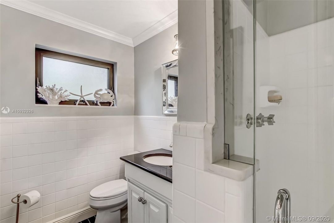 Full bathroom downstairs remodeled with new vanity, toilet, floor tile.  An enlarged shower opening with installed glass door.