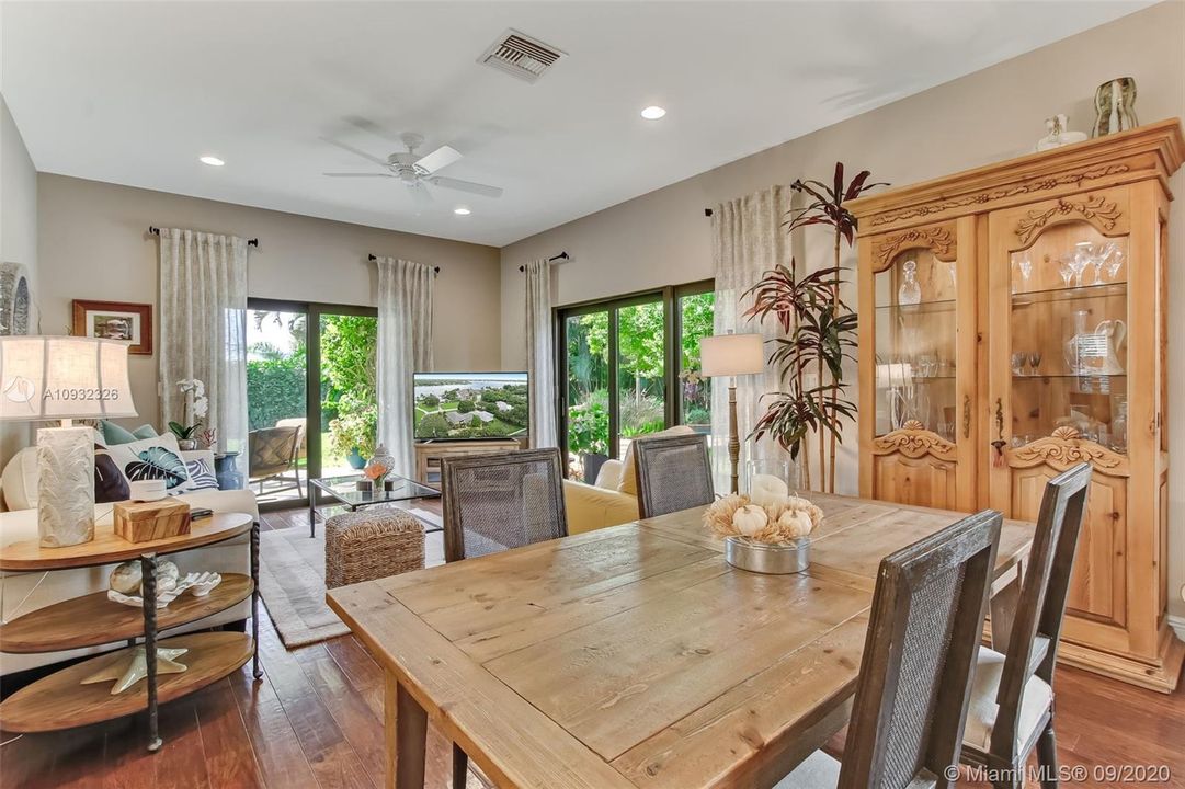 Living room and dining area in guest house opens to large covered patio.