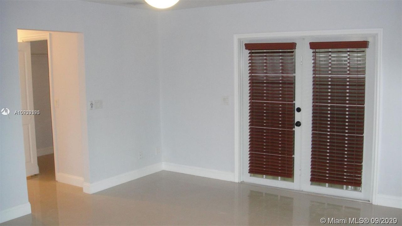 MASTER BEDROOM - DOUBLE DOORS LEADING TO THE POOL AREA