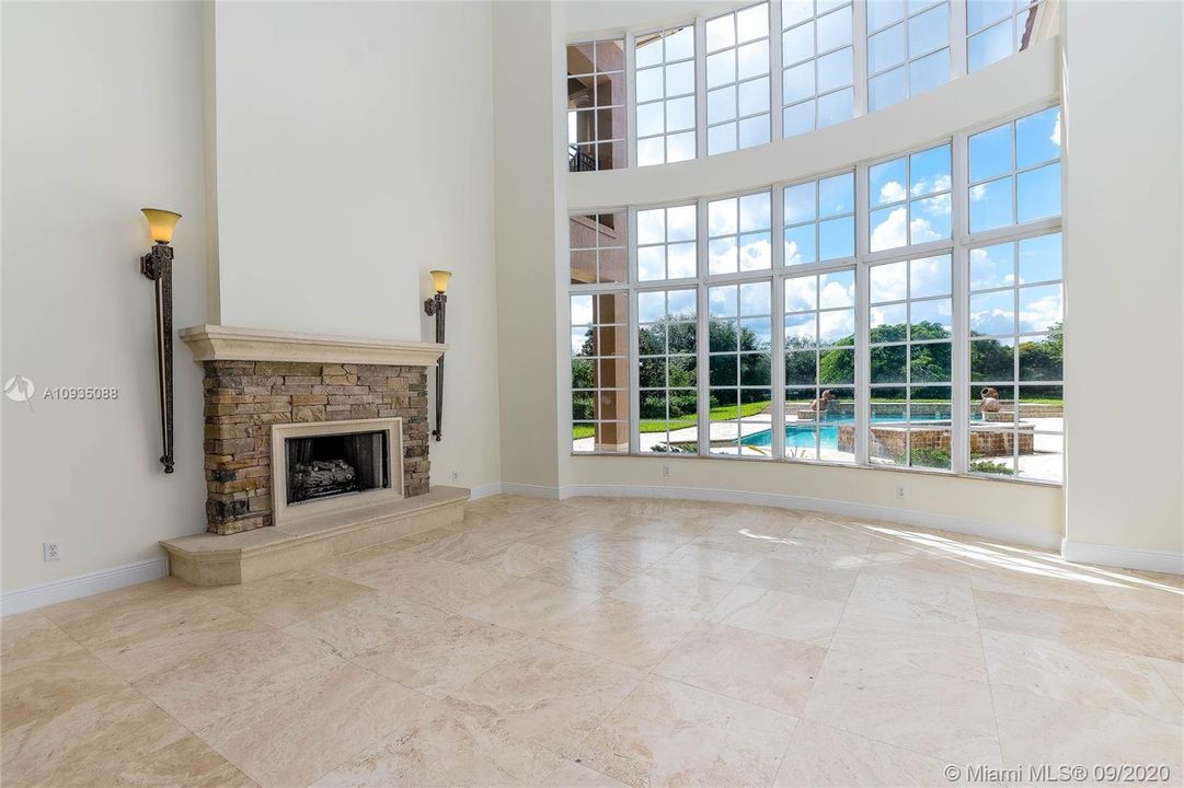 FORMAL LIVING ROOM WITH OVER 20FT CEILINGS AND PICTURE PERFECT WINDOWS. MARBLE FLOORS.