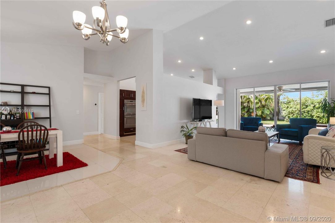 View from the main entrance to the family/living room with generous flow of natural light thanks to the large french doors and high ceilings.