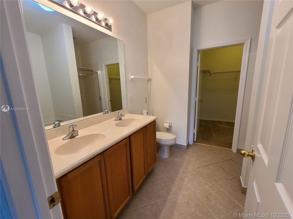 Mster Bath - Upgrades include the double sink vanity, and separate tub and shower.  A large walk-in closet can be seen in the background.