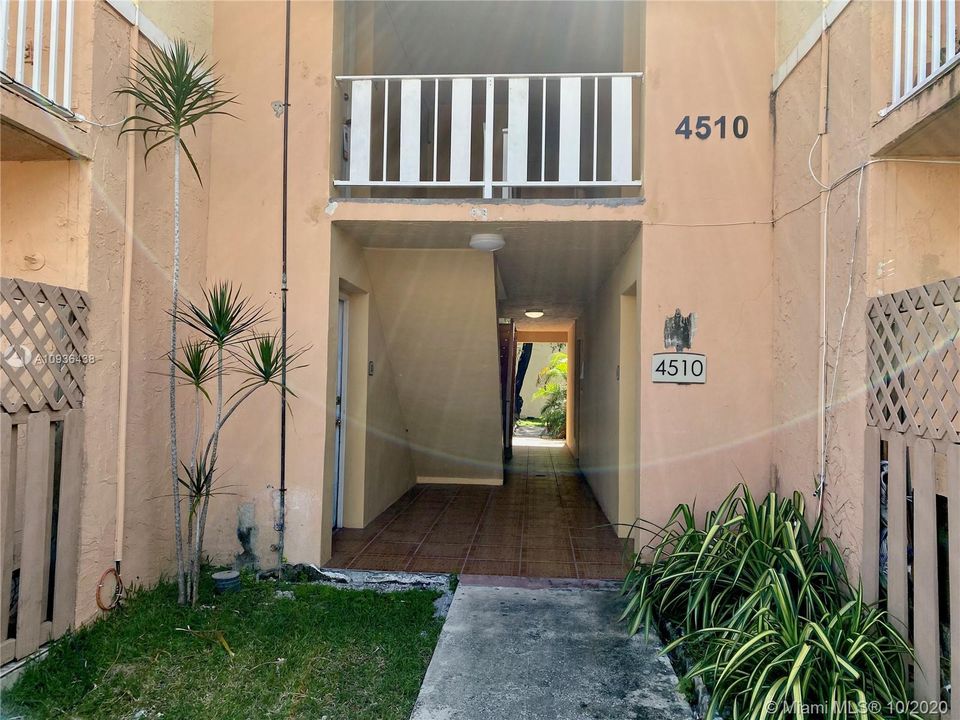 Walkway leading to the subject property (First door on left).