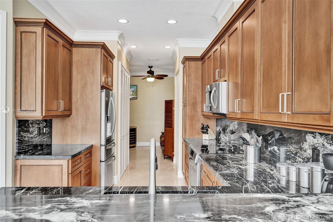 KITCHEN VIEW WITH FULL SIZE LAUDRY CLOSET TO LEFT AND BONUS ROOM