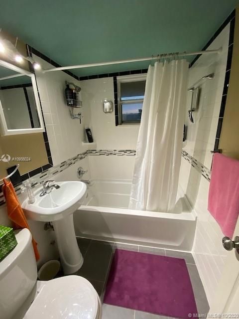 Updated bathroom includes new toilet, pedestal sink, and largo confortable tub.