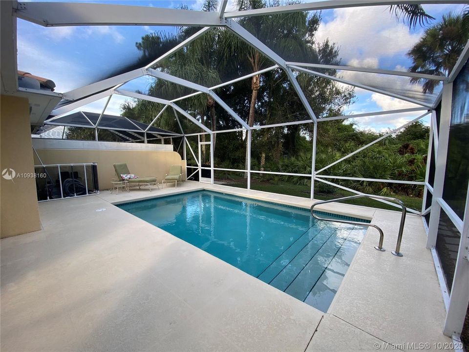 View from patio of pool with tropical preserve