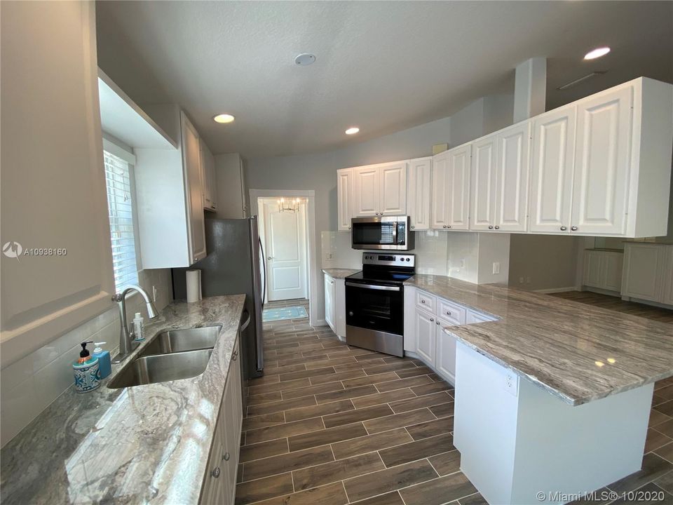 kitchen with all new appliances and granite countertops