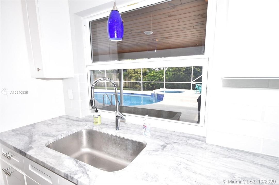 Enjoy the view of the pool and patio area from your kitchen sink