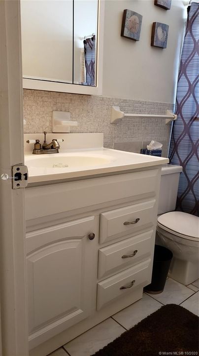 GUEST BATHROOM SINK AND CABINET