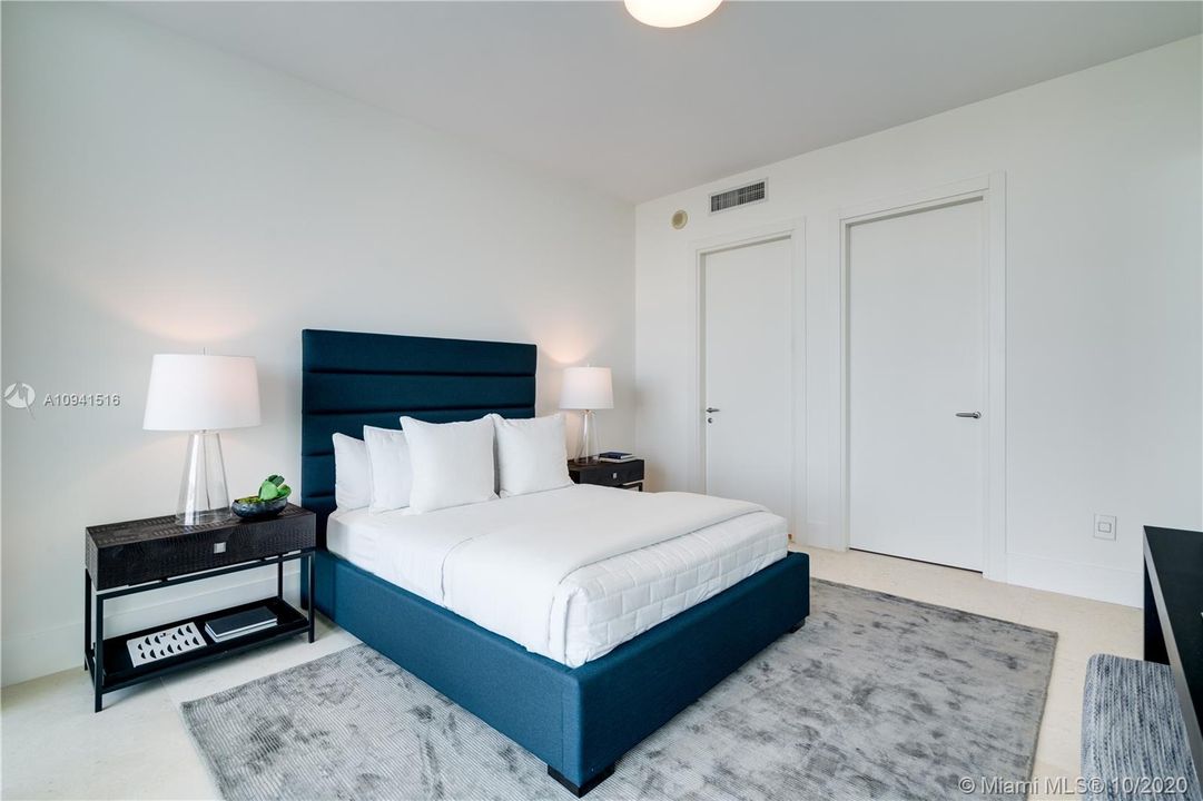 Bedroom with balcony access and city views