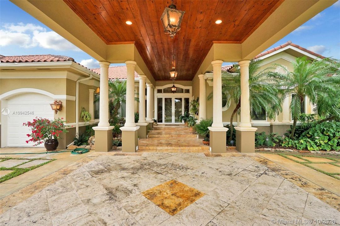 Grand entrance; carport has space for two cars.