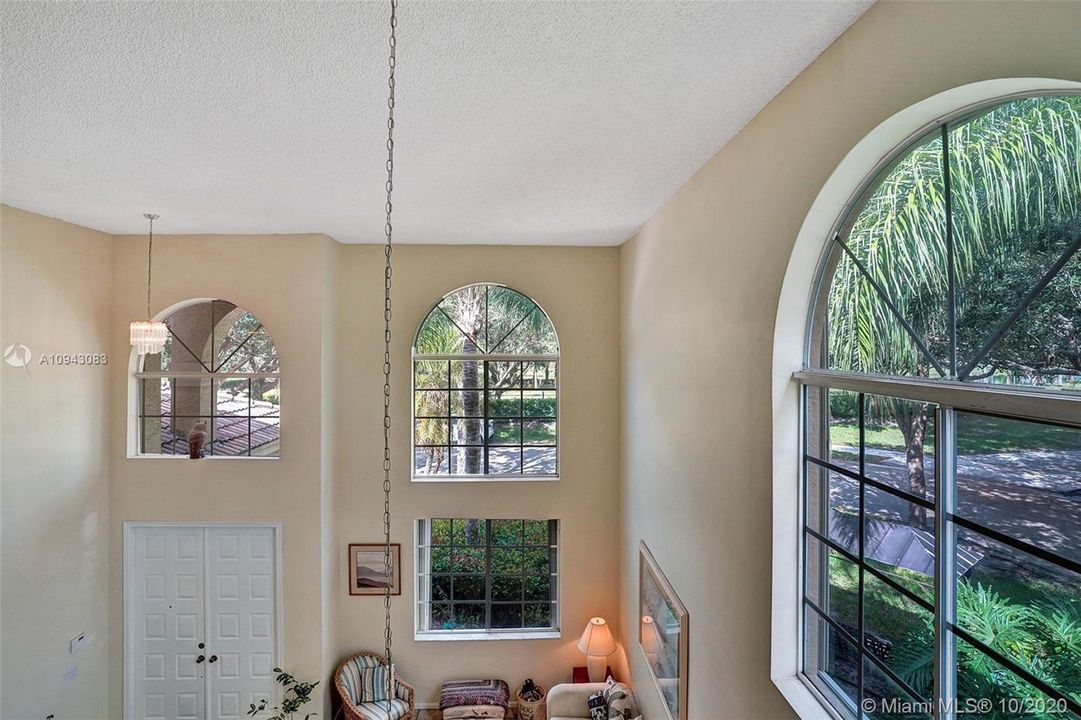 Soaring 18' ceilings and bursting with sunlight through the arched clerestory windows.