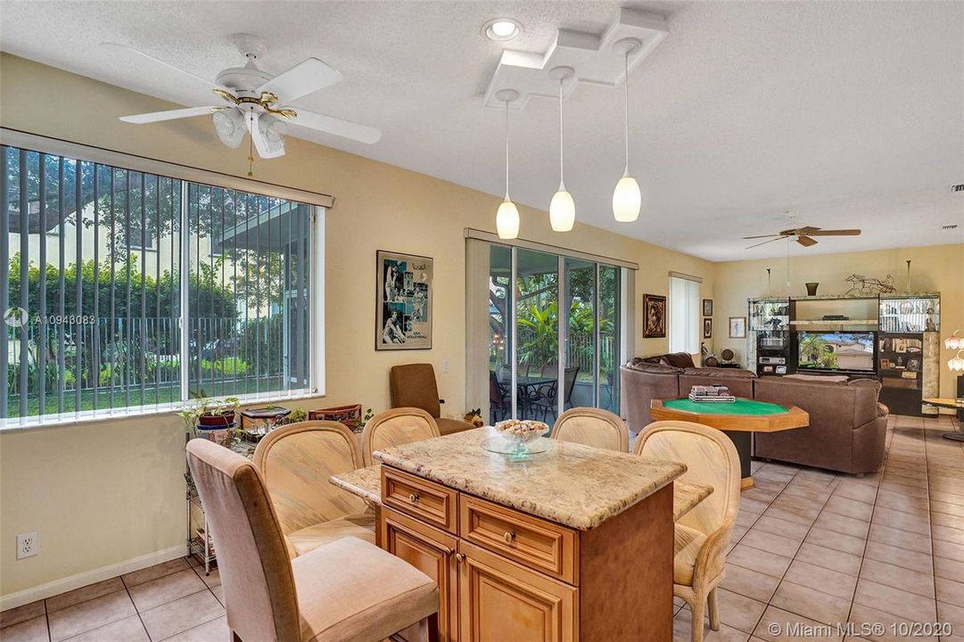 Kitchen includes a custom-designed granite island and breakfast bar.