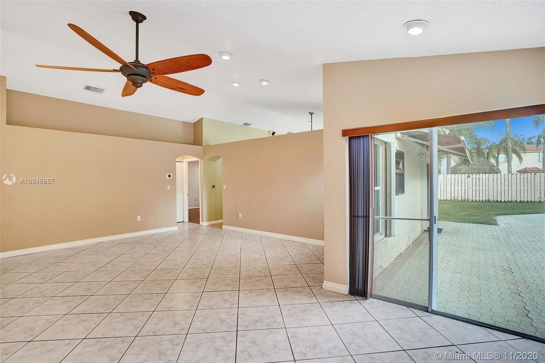 Lots of natural light in the living room, view of pool, vaulted ceilings