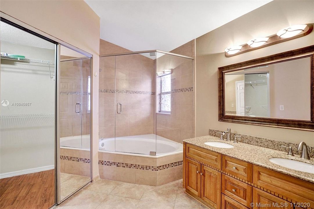 soak all your cares away in this corner roman tub in the master bathroom