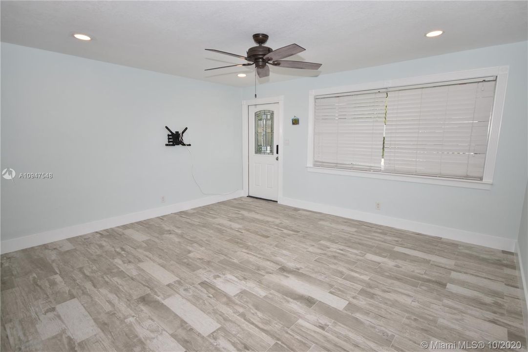 Spacious Living Room with Porcelain Wood Looking Tile throughout whole house