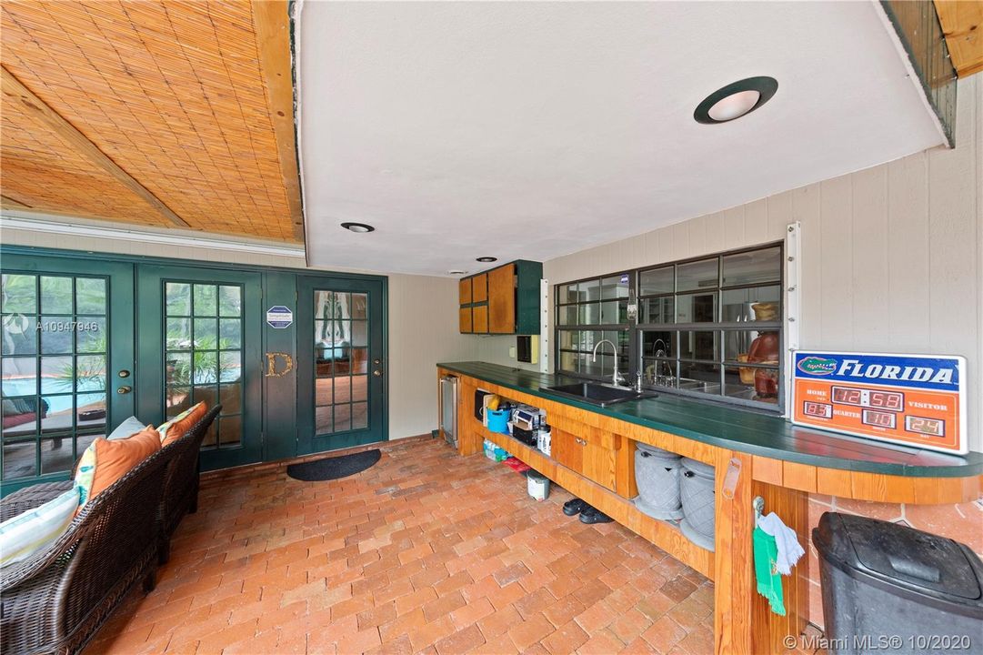 PAVERED, SCREENED POOL AREA WITH SUMMERSTYLE KITCHEN, BEVERAGE REFRIGERATOR, SINK, FRENCH DOORS LEADING TO THE POOL DECK FROM THE MASTER BEDROOM, FAMILY ROOM, KITCHEN, AND GUEST  BEDROOM