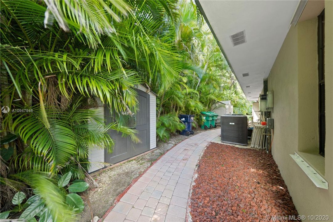 PAVED WALK WAYS AROUND THE PROPERTY, 2 LARGE SHEDS, WELL FOR IRRIGATION, FULL HURRICANE PROTECTION W/ SHUTTERS.