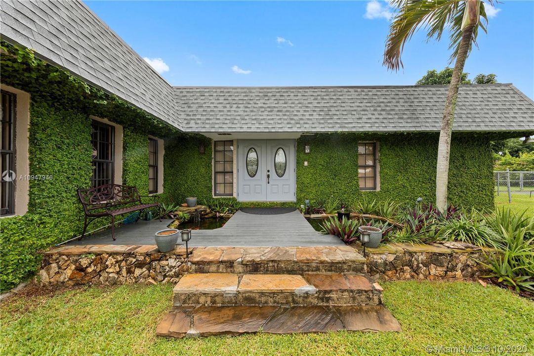 LUSHLY LANDSCAPED FRONT ENTRANCE W/ FOUNTAIN & POND WITH GOLDFISH...