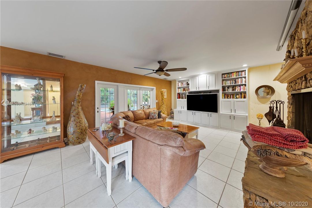 OPEN FLOOR PLAN FAMILY ROOM W/FIREPLACE & FRENCH DOORS LEADING TO THE RESORT STYLE POOL.