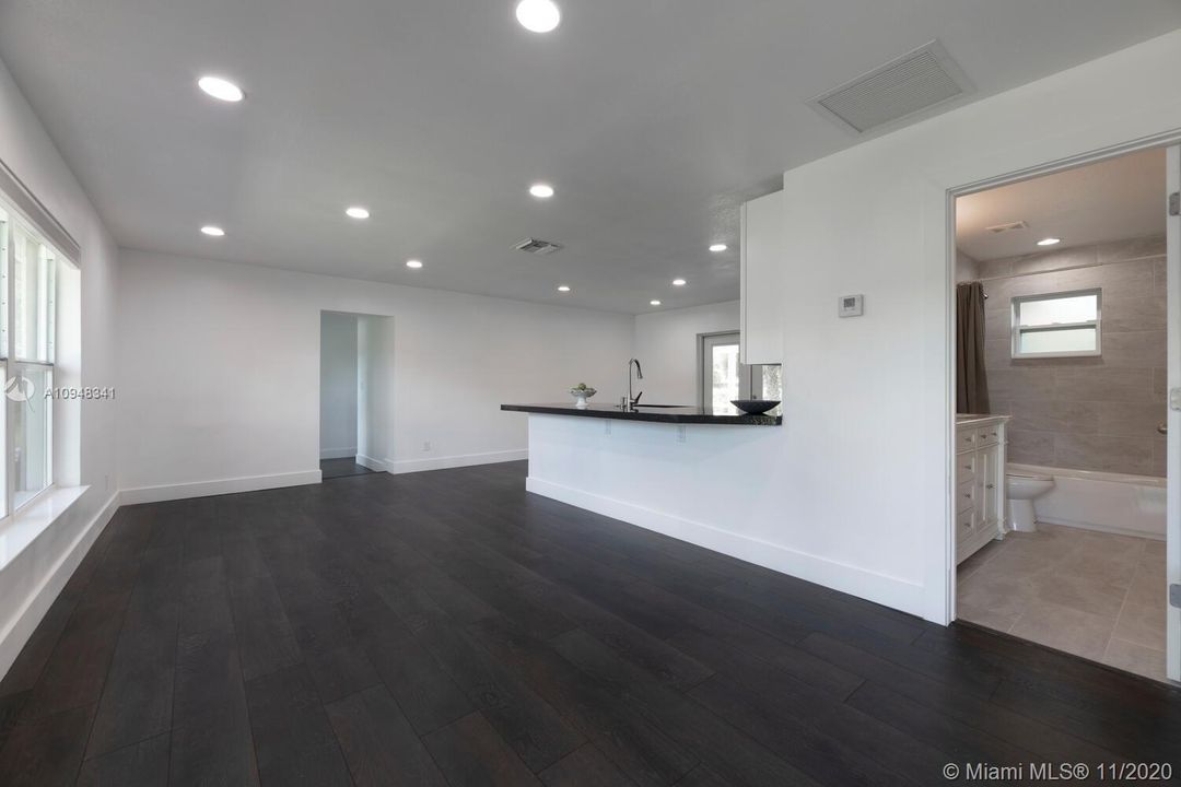 VIEW FROM ENTRANCE- GUEST BATH, LIVING AREA, EAT IN KITCHEN, 6" baseboards