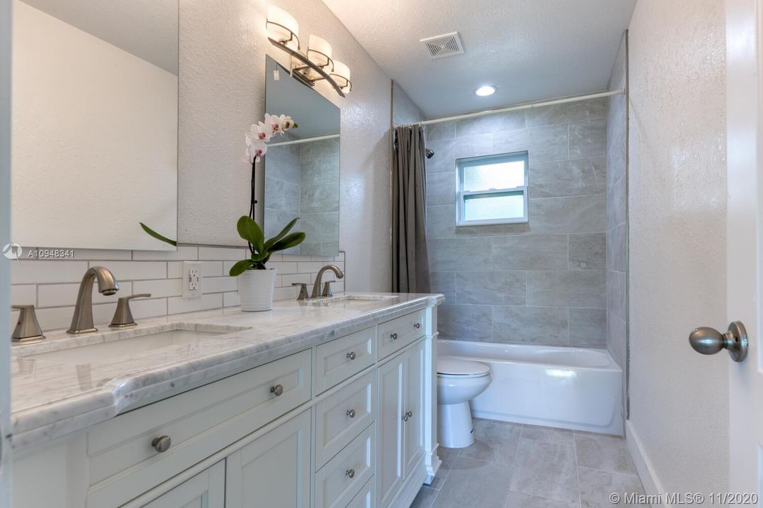 NEW 72" double vanity, new tub, new tile