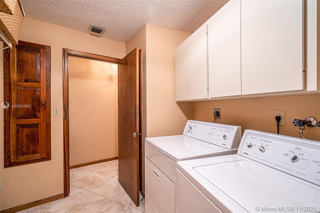 Spacious Laundry room with custom pull down ironing board