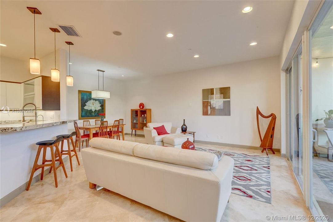 Bright, Open Concept Living Room, with dining room area and Breakfast Counter in Kitchen