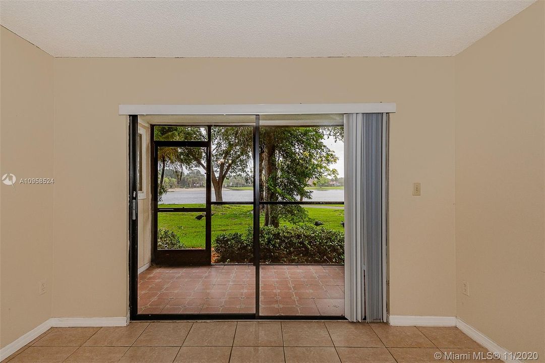 The sliding door opening to the screened patio to enjoy the lake view.