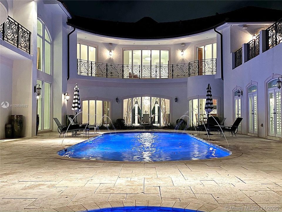 Exterior Back Night View with Pool Lights & Fountains
