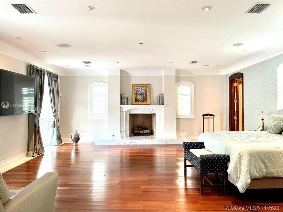 Master Bedroom Suite with working Fireplace and Brazilian Mohagony wood floors