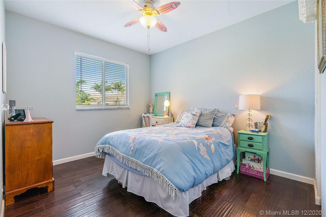 Bedroom #3 with wood floors and wood blinds. 9"ceiling.