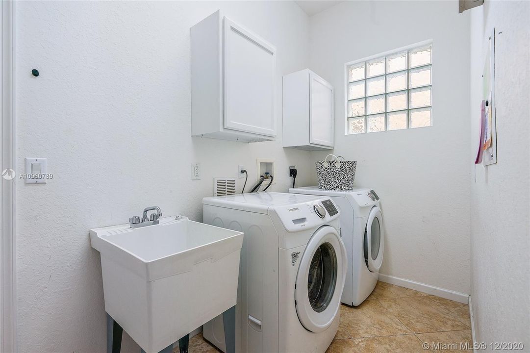 Laundry/ utility room with 2 closets for extra storage. Approximate 5x12 with ceramic tile floors.