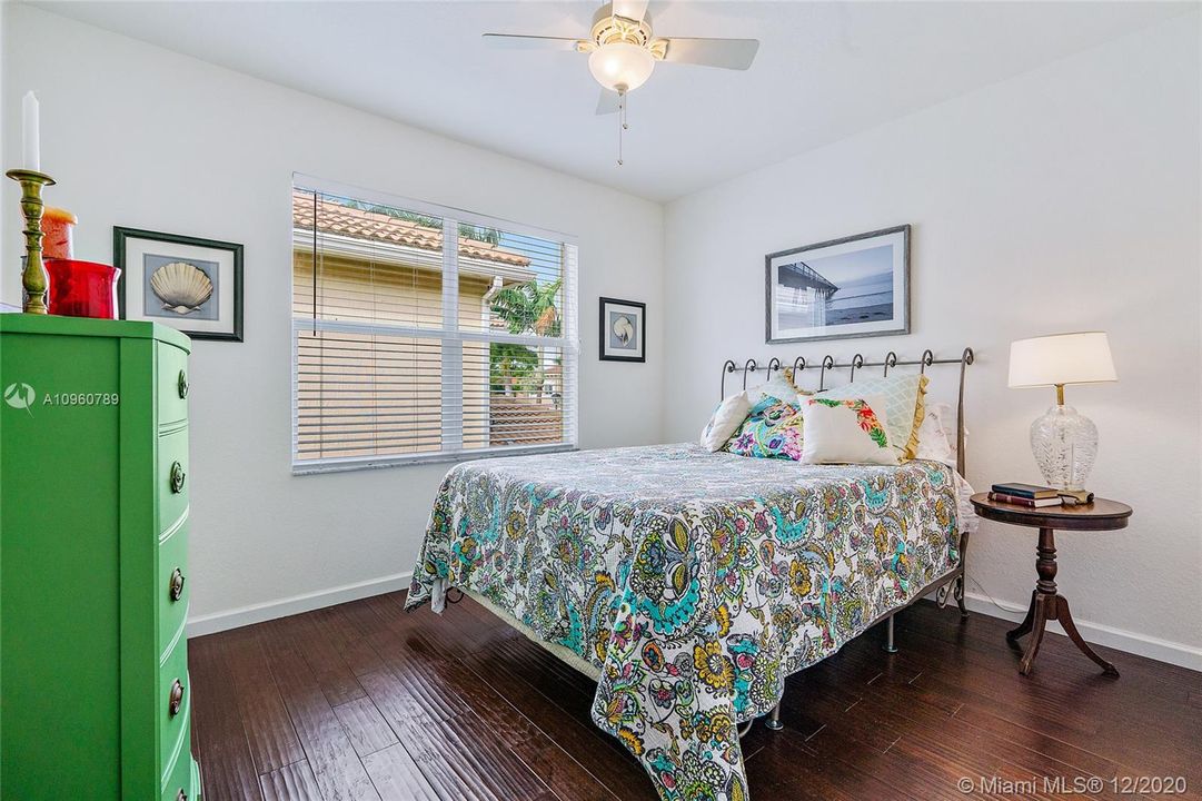 Bedroom #2 with wood floors and wood blinds. 9"ceiling.