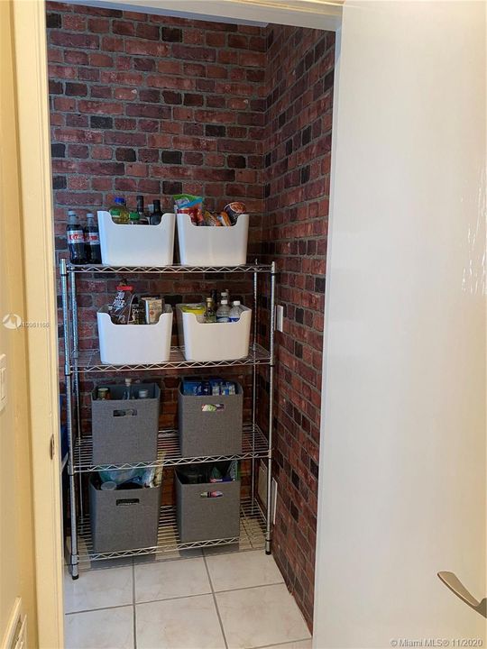 Pantry / Laundry room off of the kitchen with nice wallpaper detail